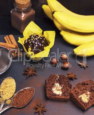 chocolate cupcakes with banana filling on a black surface