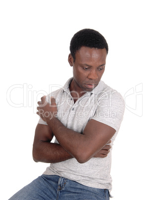 A sad looking black man sitting