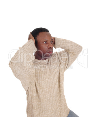 Upset African man with hands on head