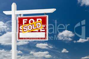 Right Facing Sold For Sale Real Estate Sign Over Blue Sky and Cl