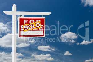 Right Facing Sold For Sale Real Estate Sign Over Blue Sky and Cl