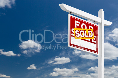 Left Facing Sold For Sale Real Estate Sign Over Blue Sky and Clo