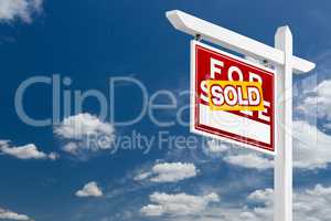 Left Facing Sold For Sale Real Estate Sign Over Blue Sky and Clo