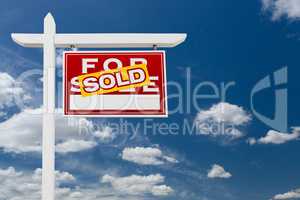 Right Facing Sold For Sale Real Estate Sign Over Blue Sky and Cl
