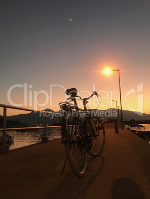The retro bicycle, pier, fence and gradient sunset