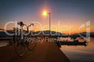 Retro bicycle, pier, fence and gradient sunset