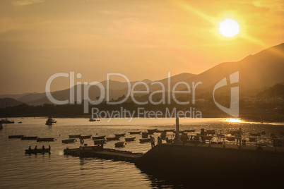 Sun, mountain, blue sky, boats, yacht and sailboats at sunset