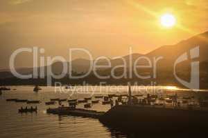 Sun, mountain, blue sky, boats, yacht and sailboats at sunset