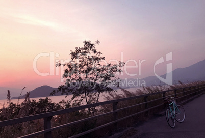 Mint green retro bicycle, mountain, lake and gradient sky