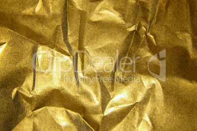 Golden shiny abstract metallic crumpled paper background