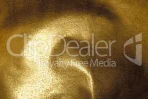 Golden shiny abstract metallic crumpled paper background