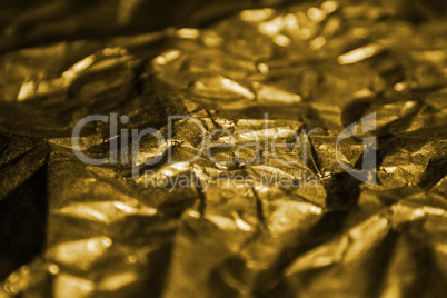 Golden shiny abstract metallic crumpled paper background