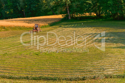 in the distance a tractor working in a field, farmland, agricultural fields
