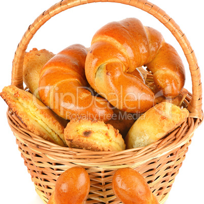 Croissants and cottage cheese rolls in wicker basket isolated on