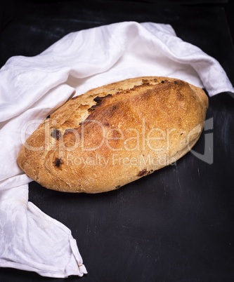 whole loaf of bread from white wheat flour with raisins