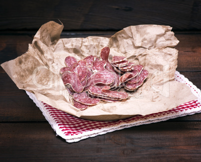 sliced smoked salami on brown paper