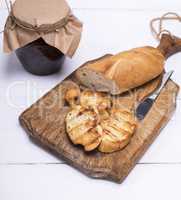 pieces of white bread on a brown wooden board and raspberry jam