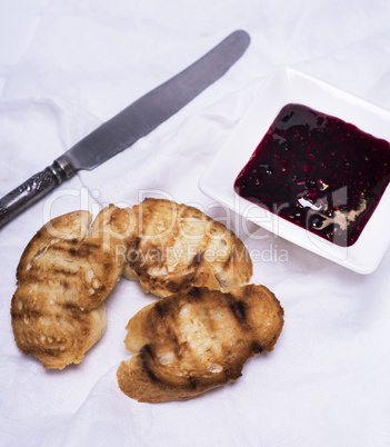 fried pieces of white bread and raspberry jam