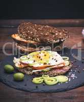 Sandwich with fried egg and a piece of rye bread
