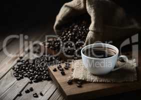 coffee cups and coffee beans on a wooden table