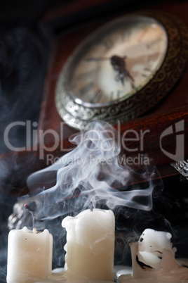 Extinguished Candles Near Clock