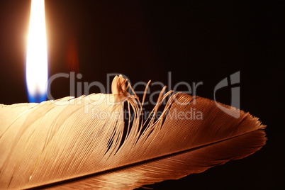 Lighting Candle Near Feather