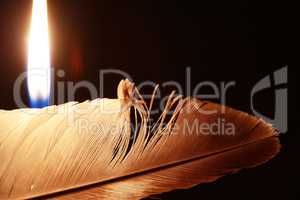 Lighting Candle Near Feather