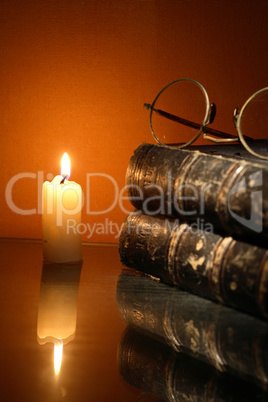 Lighting Candle Near Book