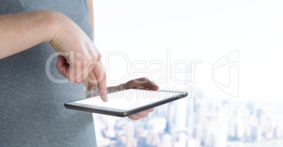 Hand holding tablet with city