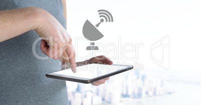 Hand holding tablet with wifi signal icon