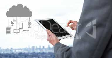 Hand holding tablet with cloud icon and hanging connection devices