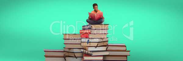 Boy reading and sitting on a pile of books and green background