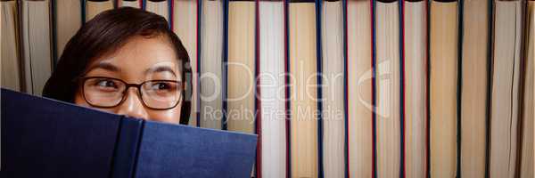 Young woman with a book looking right in front of books