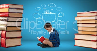 Boy reading surrounded by pile of books and a drawing with blue background