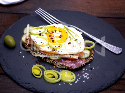 Sandwich with fried egg and a piece of rye bread