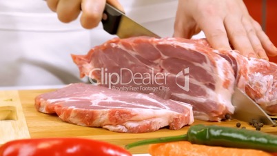 Slicing fresh raw meat for cooking