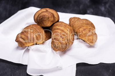 tasty baked croissants on a white napkin