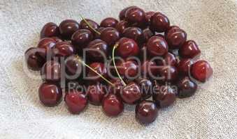 Ripe cherries on the table on a napkin.