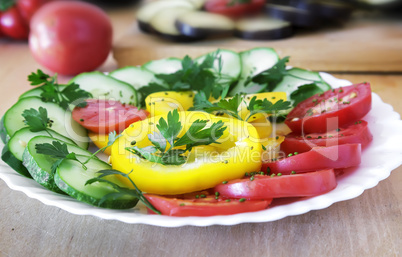 Cut vegetables on a plate on the table.