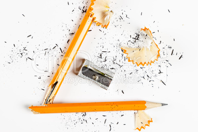 Broken pencil with metal sharpener and shavings.