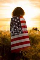 Girl Teenager Woman Wrapped in USA Flag in Field at Sunset