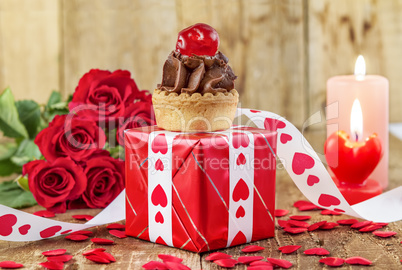 Cupcake with cherry over red gift box