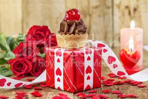 Cupcake with cherry over red gift box