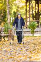 Senior woman with walker walking outdoors