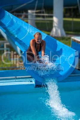 Beautiful girl on water slide at water park in Summer holiday from Hungary