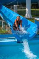 Beautiful girl on water slide at water park in Summer holiday from Hungary
