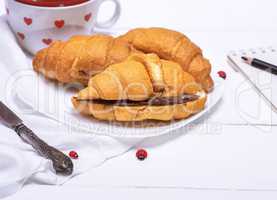 baked croissants with chocolate on a white plate