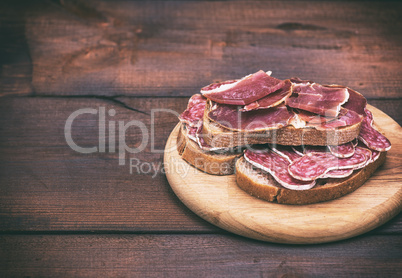 sandwiches with smoked sausage salami and pieces of hamon