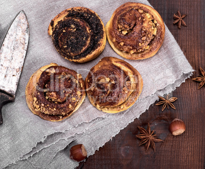 round buns with cinnamon and poppies on a gray textile napkin