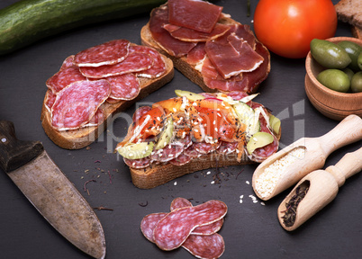 sandwiches with pieces of sausage salami and a hamon
